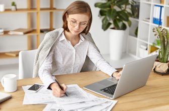 elegant businesswoman dressed formally sitting with laptop