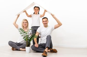 happy family sitting together making home sign