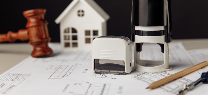 judge wooden gavel stamp model house with blueprint