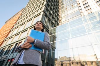 low angle businesswoman holding clipboard city